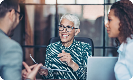 Business woman smiling with two work colleagues in office