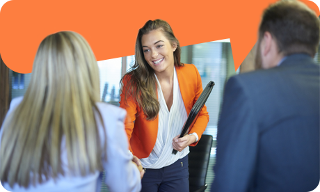 Young woman shaking hands with work colleagues in office